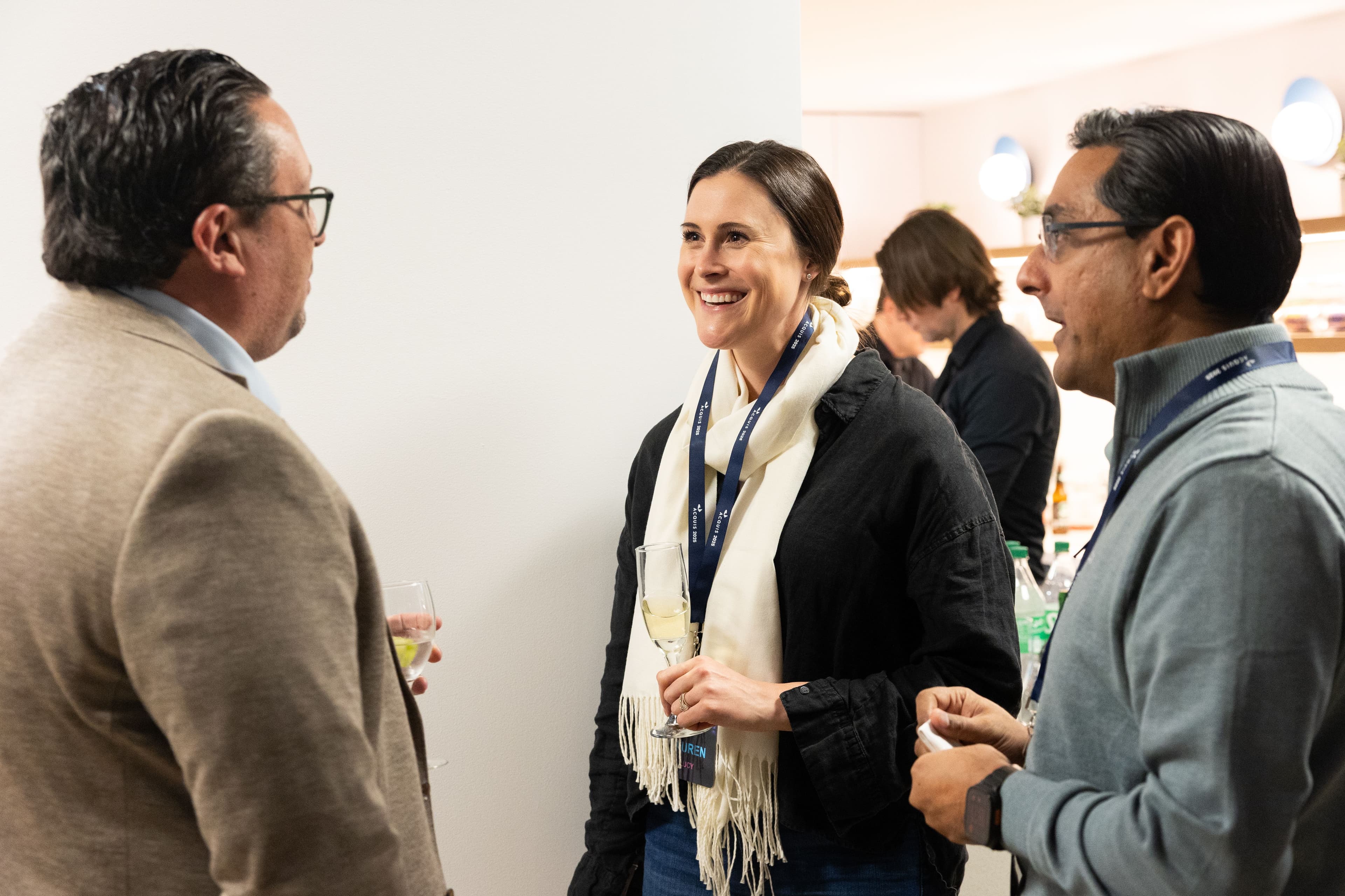 Lauren Lucy, Kerby Houff, and Rishi Thukral from Acquis having a conversation