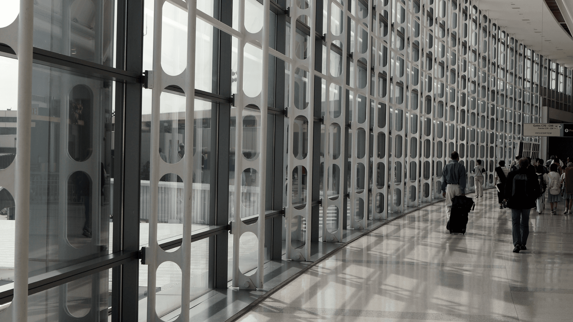 travelers walking in modern airport terminal